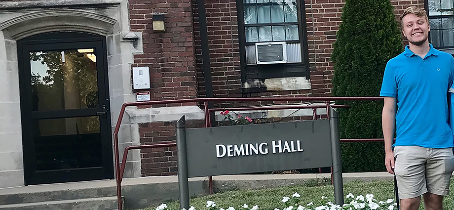 Jake Beckmann stands in front of Deming Hall.